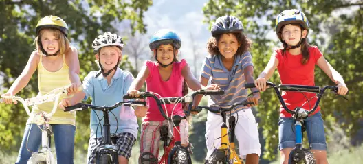 kids on bikes wearing helmets